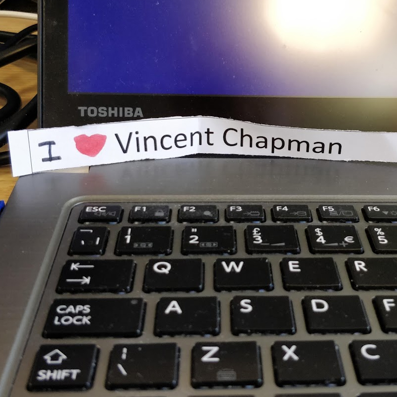 A laptop keyboard with a paper sign reading I love Vincent Chapman placed across the keys.